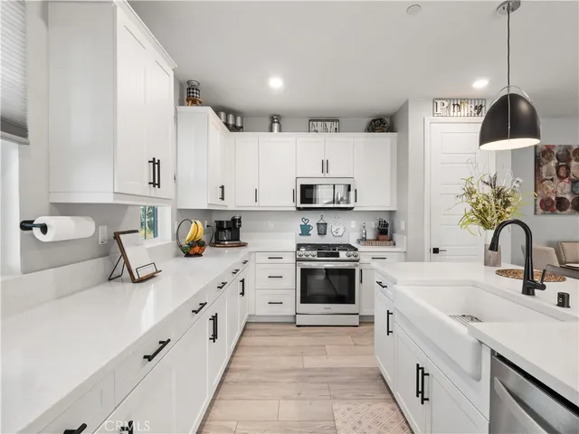 a kitchen with kitchen island granite countertop white cabinets and white appliances