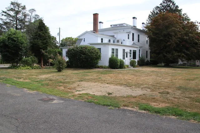a front view of a house with a garden