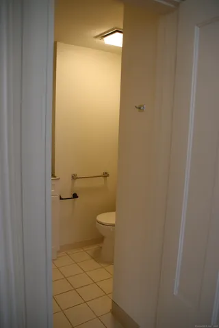 a bathroom with a granite countertop toilet and a shower