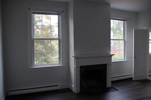 a living room with a fireplace and windows