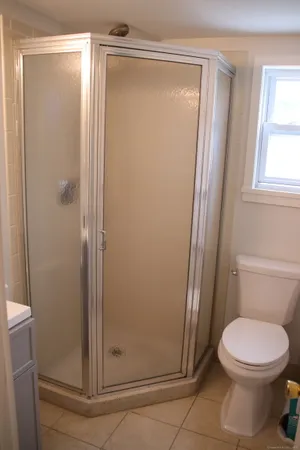 a bathroom with a toilet and a shower
