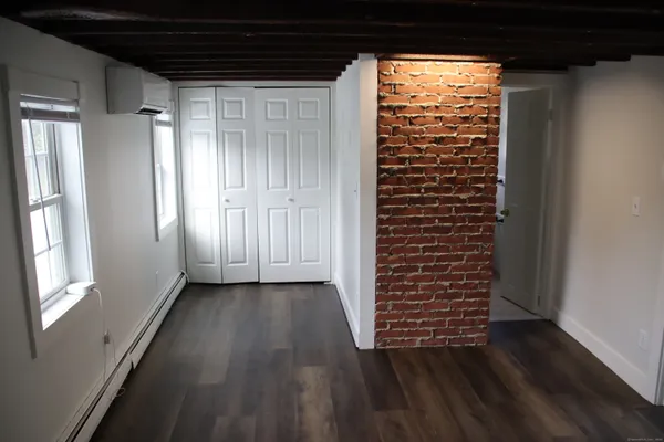 a view of a room with wooden floor and windows