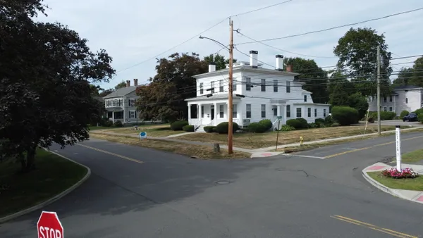 a view of a street with houses on the side