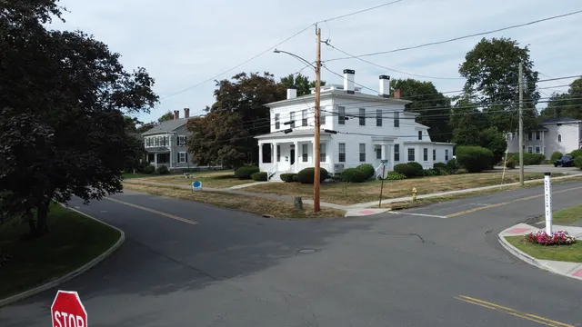a view of a street with houses on the side