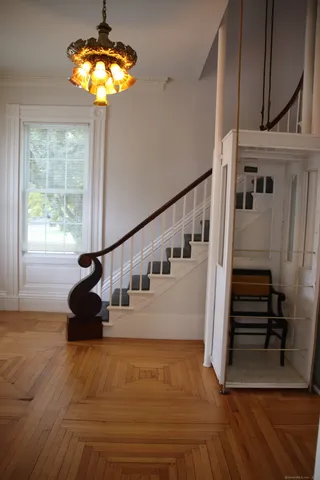 a view of entryway and hall with wooden floor