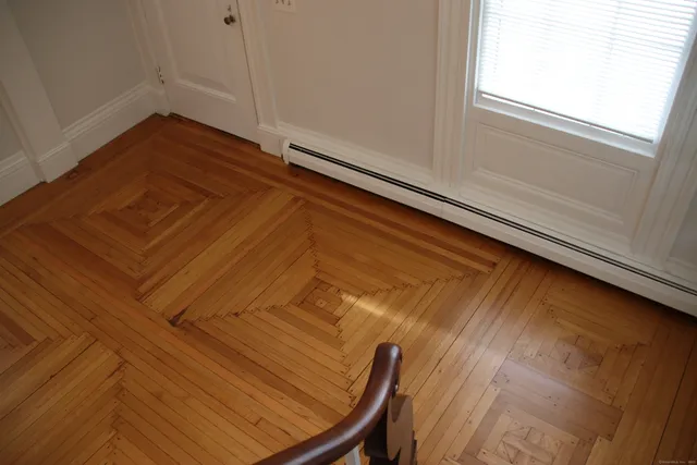a view of a room with wooden floor