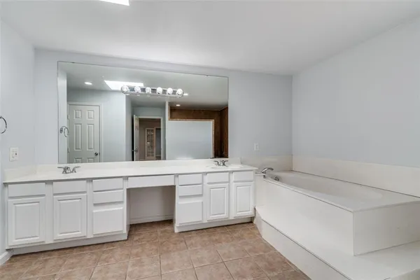 a bathroom with a sink a vanity and mirror