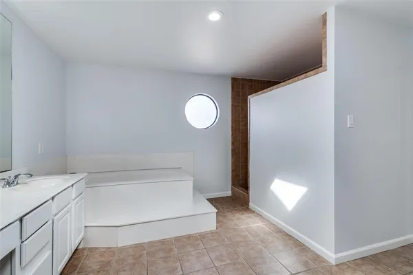 a bathroom with a sink mirror vanity and toilet