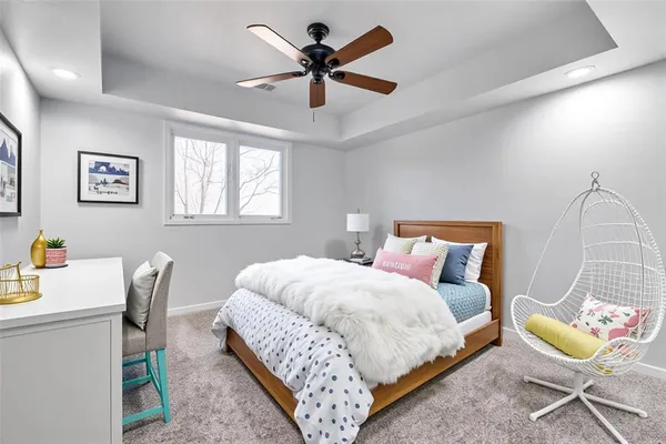 a bedroom with a bed a desk and chair