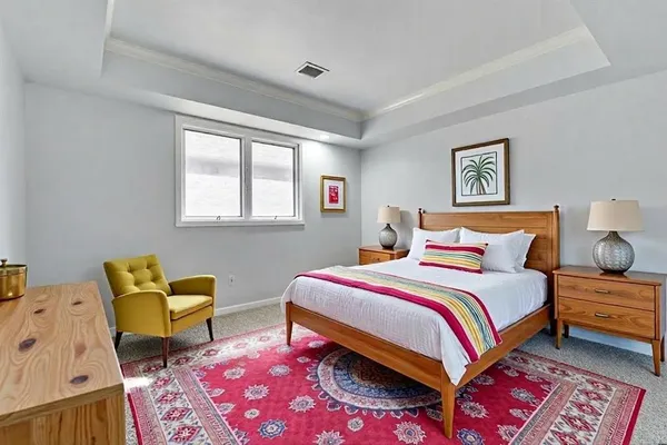 a bedroom with a bed and chair