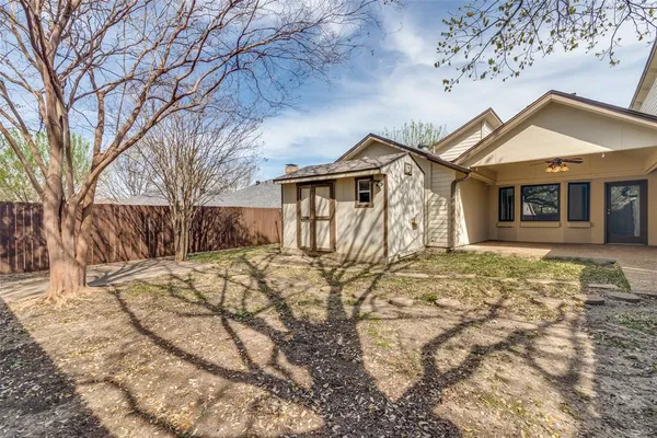 a view of a house with a yard covered in snow