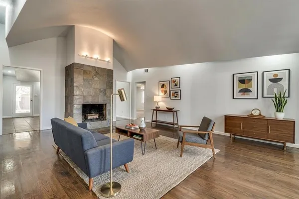 a living room with furniture and a fireplace