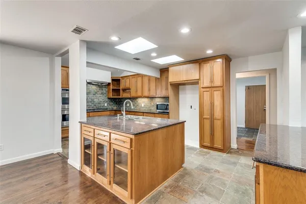 a kitchen with stainless steel appliances granite countertop a stove and a refrigerator