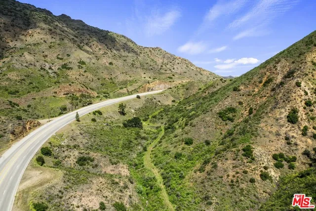 a view of a field with a mountain in the background