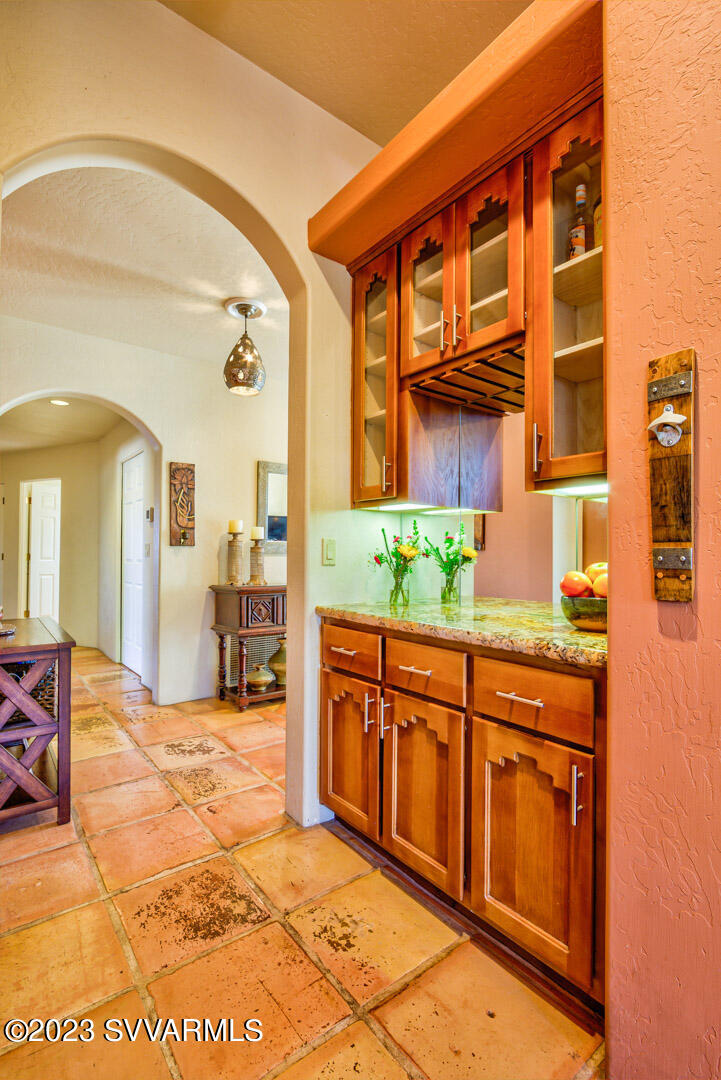 55 Roundup Road Sedona, AZ 86336 - Photo 21 of 35 a spacious bathroom with a granite countertop sink and a mirror