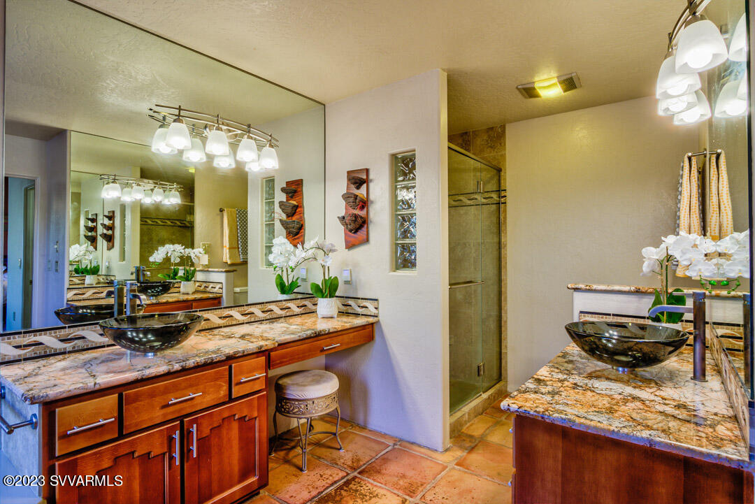 55 Roundup Road Sedona, AZ 86336 - Photo 23 of 35 a bathroom with a granite countertop sink and a mirror