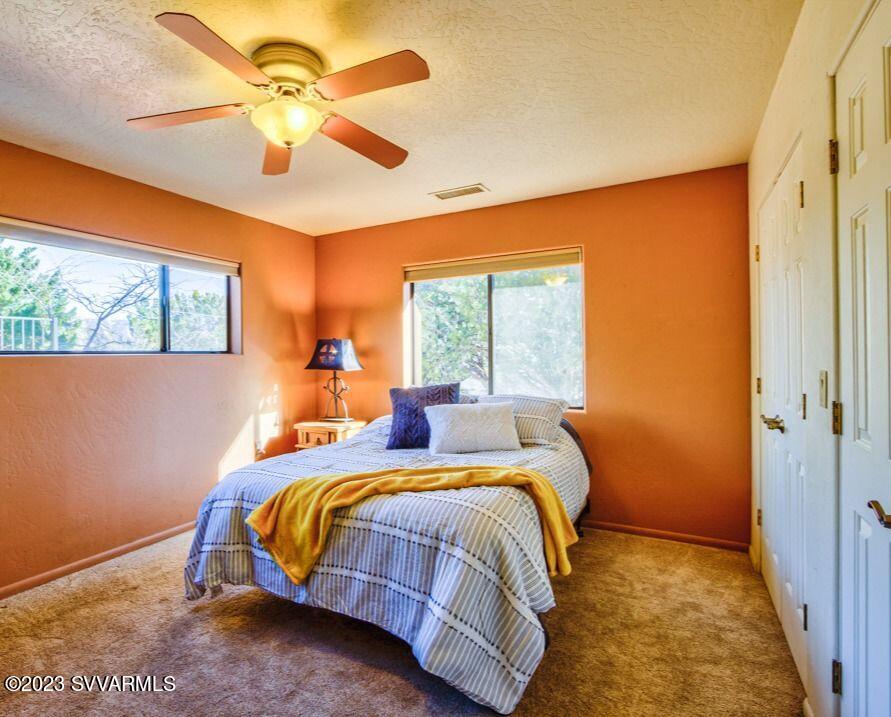 55 Roundup Road Sedona, AZ 86336 - Photo 25 of 35 a bedroom with a bed and a chandelier