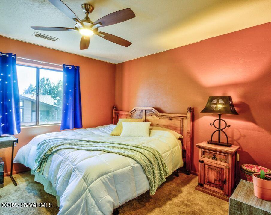 55 Roundup Road Sedona, AZ 86336 - Photo 26 of 35 a bedroom with a bed and a chandelier