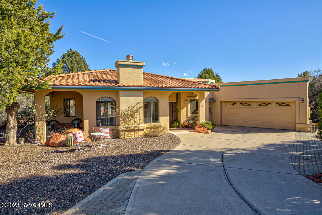 55 Roundup Road Sedona, AZ 86336 - Photo 3 of 35 a front view of a house with basket ball court and a garage