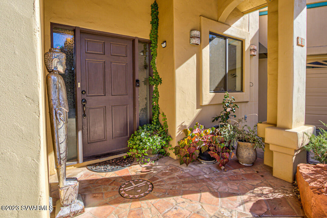 55 Roundup Road Sedona, AZ 86336 - Photo 5 of 35 a view of a entryway with flower pots