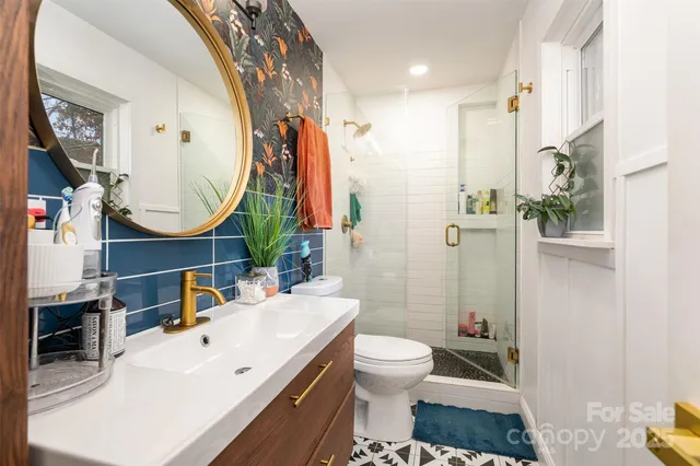 a bathroom with a sink toilet and shower