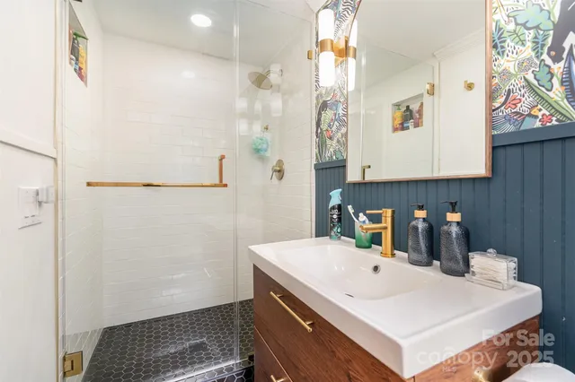 a room with a sink a refrigerator and cabinets