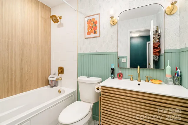 a bathroom with a sink a toilet and shower curtain
