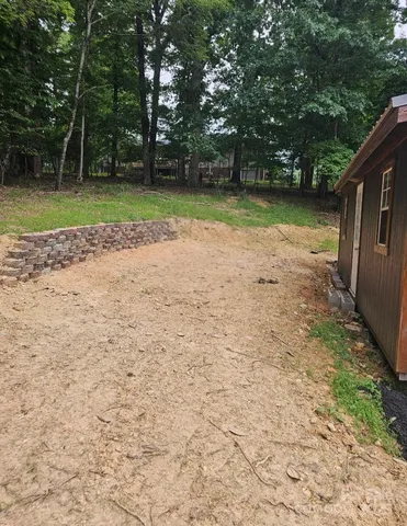 a view of a backyard with large trees