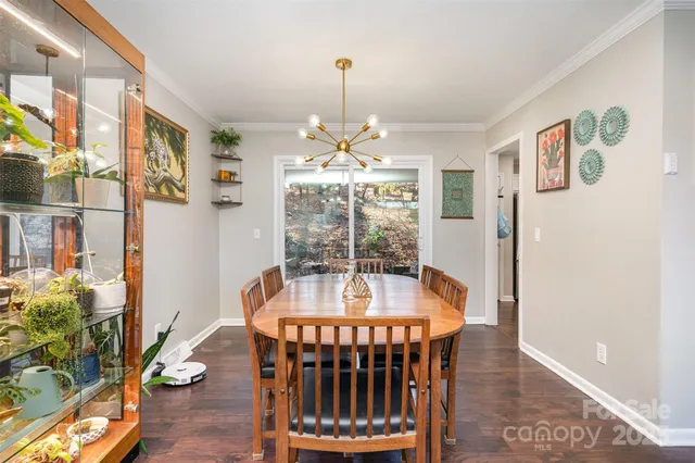a dining room with furniture window and wooden floor