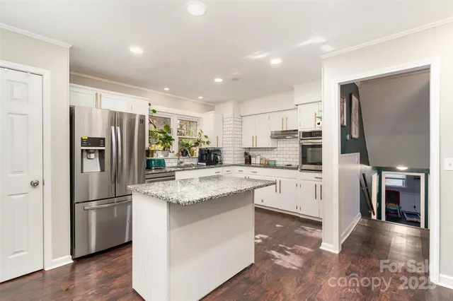 a kitchen with stainless steel appliances a sink stove and refrigerator