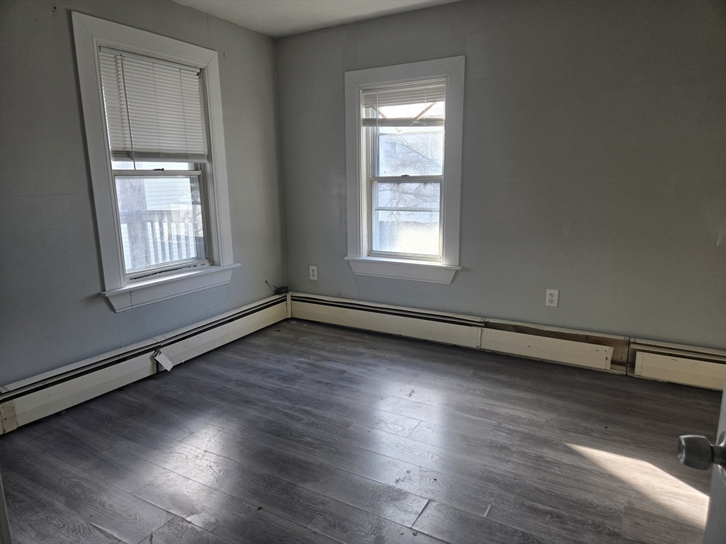 24 Caron Street Southbridge, MA 01550 - Photo 6 of 8 an empty room with wooden floor and windows