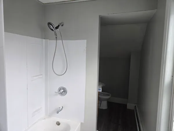 a bathroom with a glass shower door