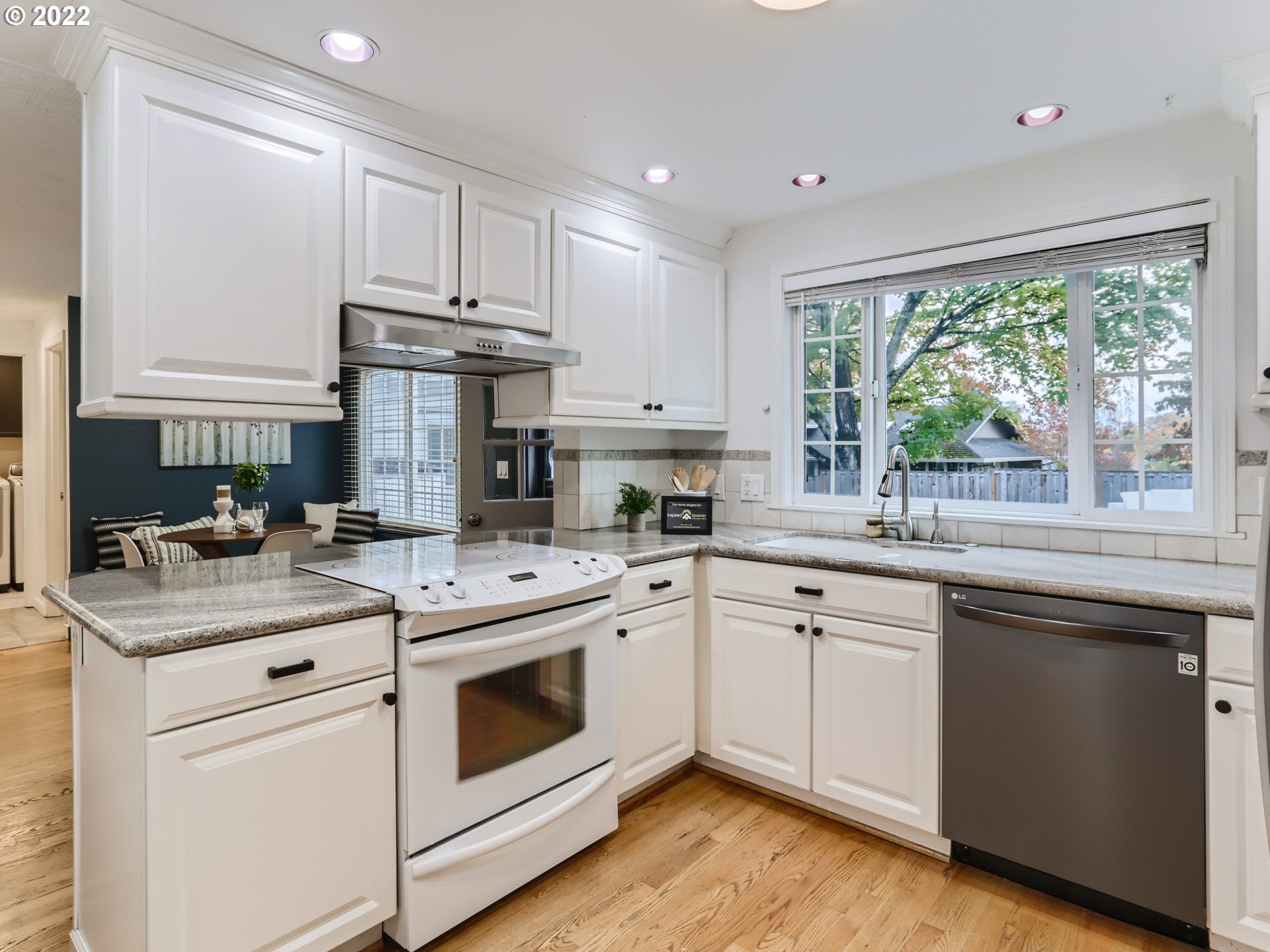 12300 Southwest Davies Road Beaverton, OR 97008 - Photo 12 of 31 a kitchen with a stove sink and cabinets