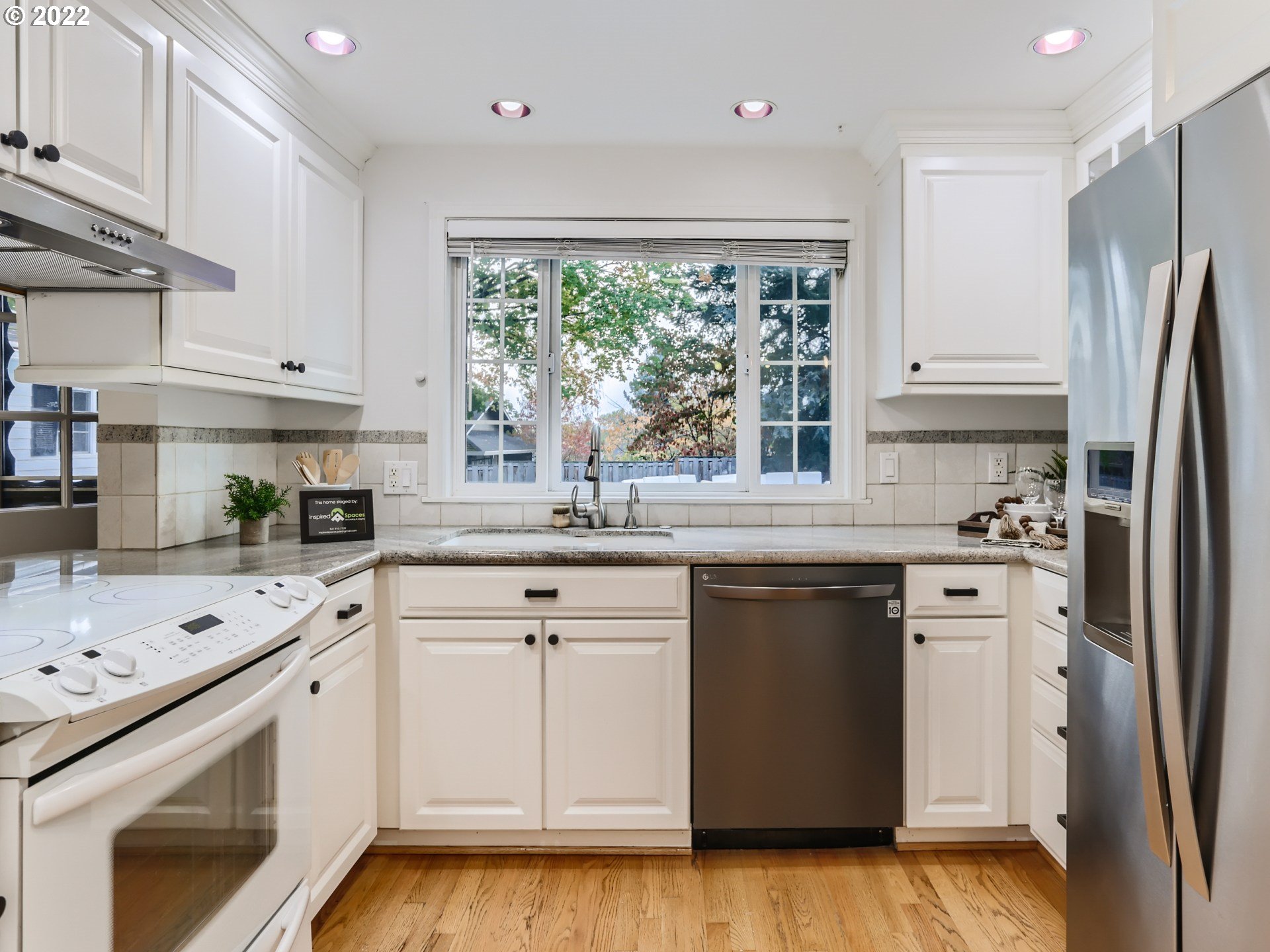 12300 Southwest Davies Road Beaverton, OR 97008 - Photo 14 of 31 a kitchen with white cabinets and white appliances