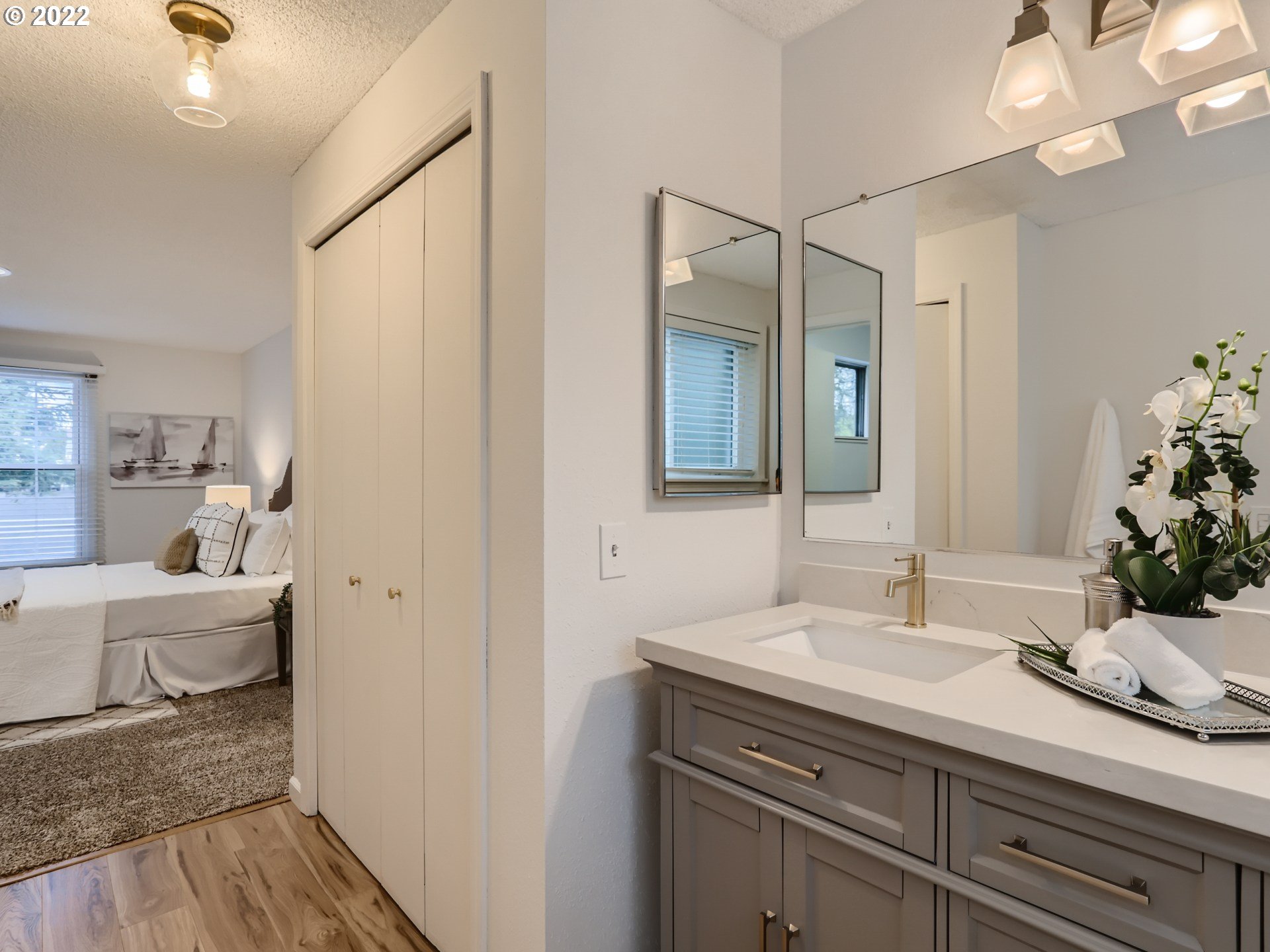 12300 Southwest Davies Road Beaverton, OR 97008 - Photo 22 of 31 a en suite bathroom with a granite countertop sink and a mirror