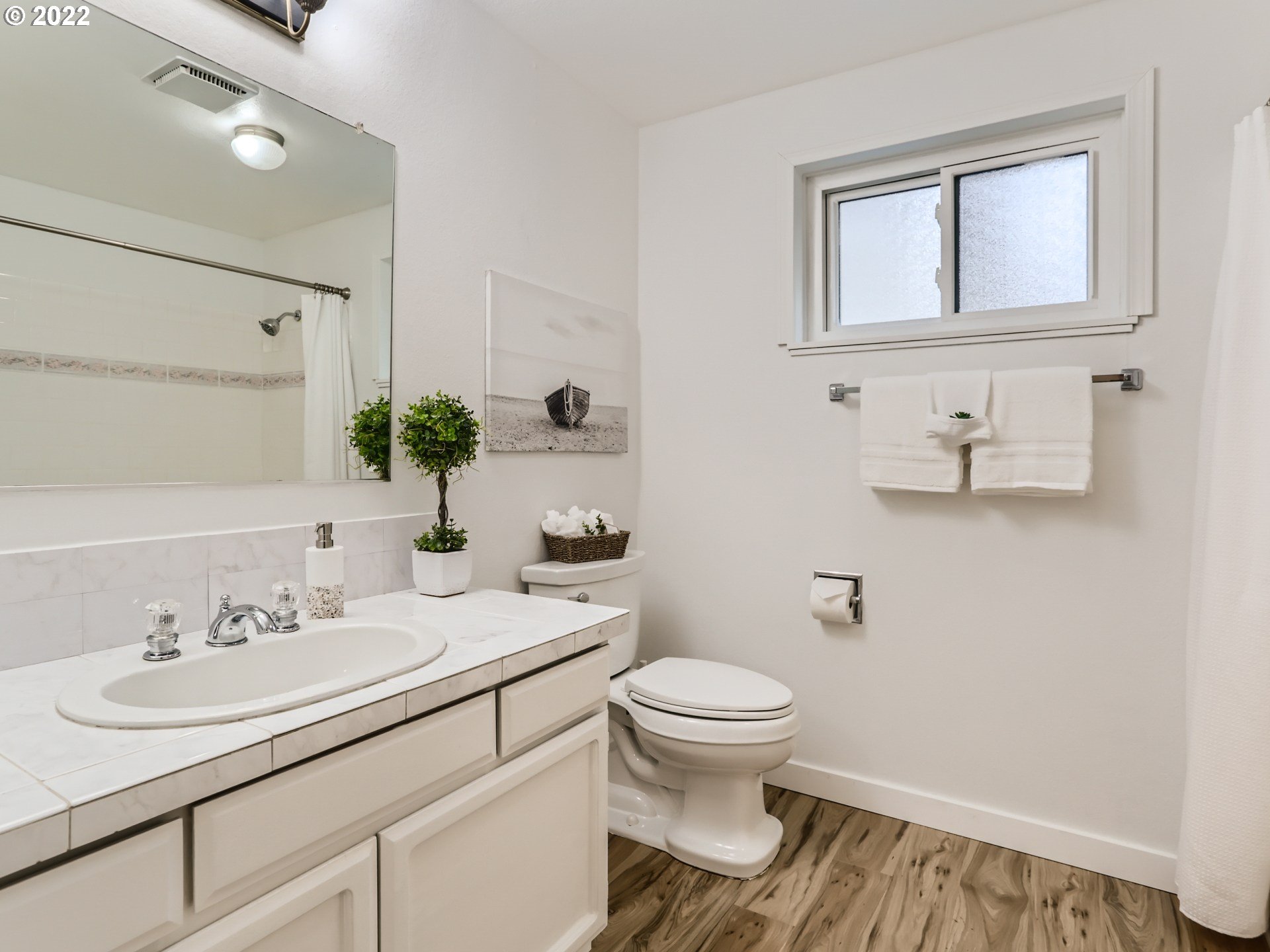 12300 Southwest Davies Road Beaverton, OR 97008 - Photo 27 of 31 a bathroom with a sink toilet and mirror