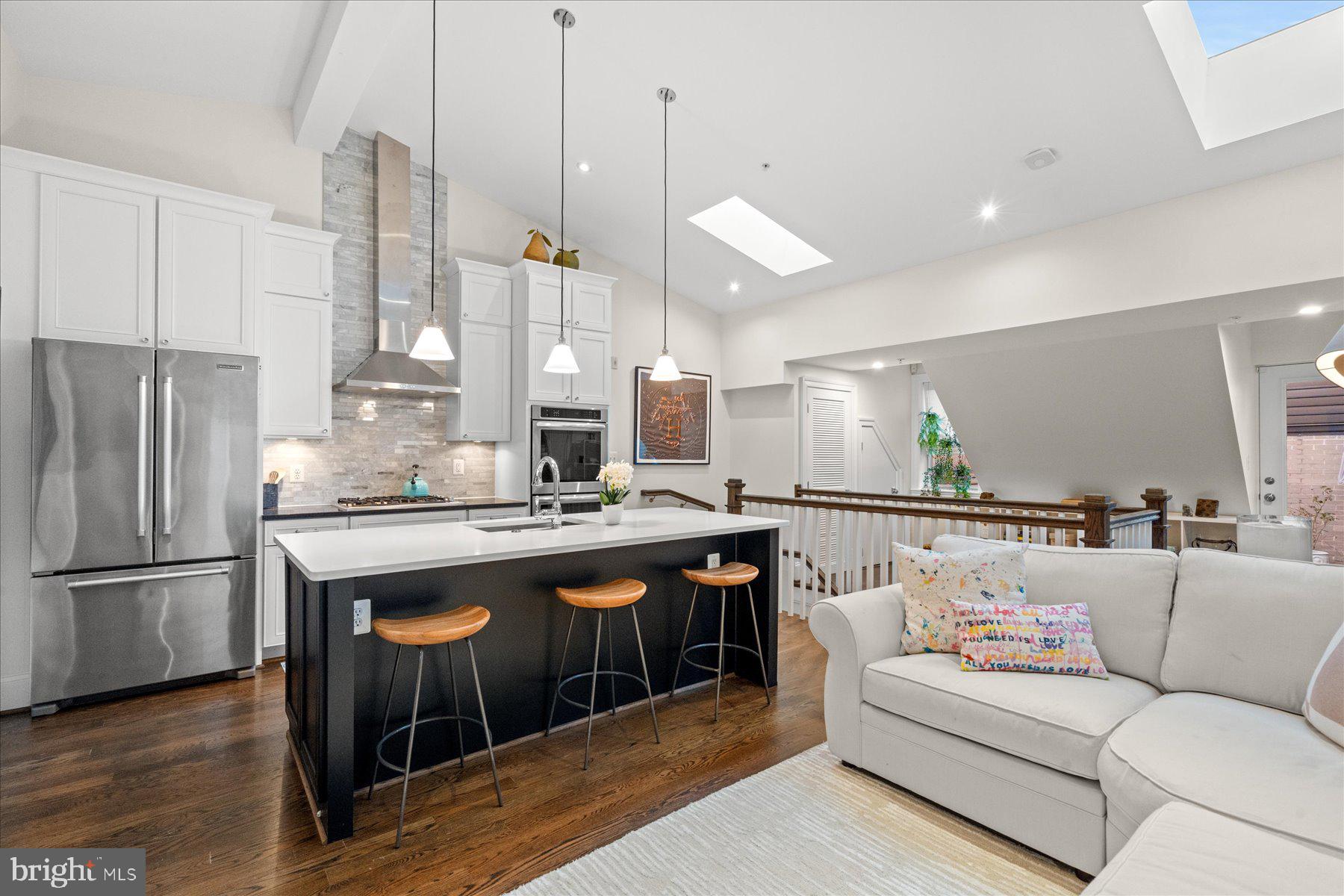 2014 Kalorama Road Northwest, Unit 7 Washington, DC 20009 - Photo 2 of 23 a kitchen with stainless steel appliances granite countertop a sink a refrigerator and a fireplace