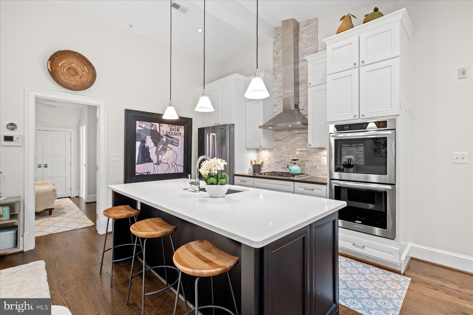 2014 Kalorama Road Northwest, Unit 7 Washington, DC 20009 - Photo 3 of 23 a kitchen with a table chairs and white cabinets