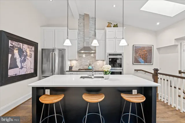 a kitchen with granite countertop a counter space dining table and chairs