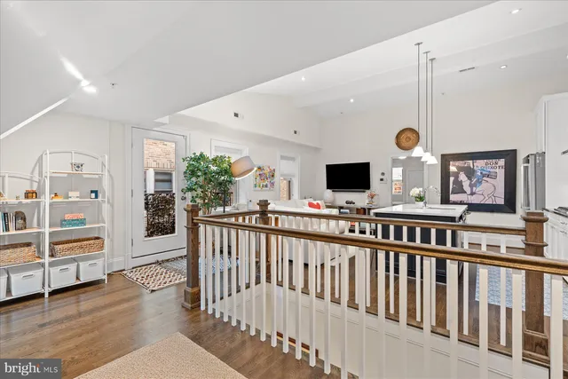 a view of a living room with furniture and flat screen tv