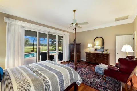 a bathroom with a double vanity sink a large mirror and a bathtub
