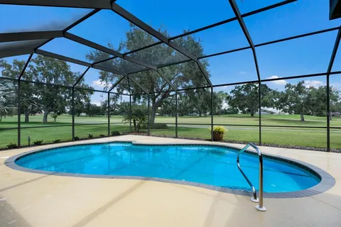 a view of a patio with a table and chairs under an umbrella