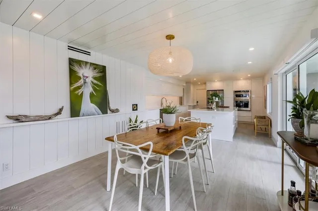 a view of a dining room with furniture and a potted plant