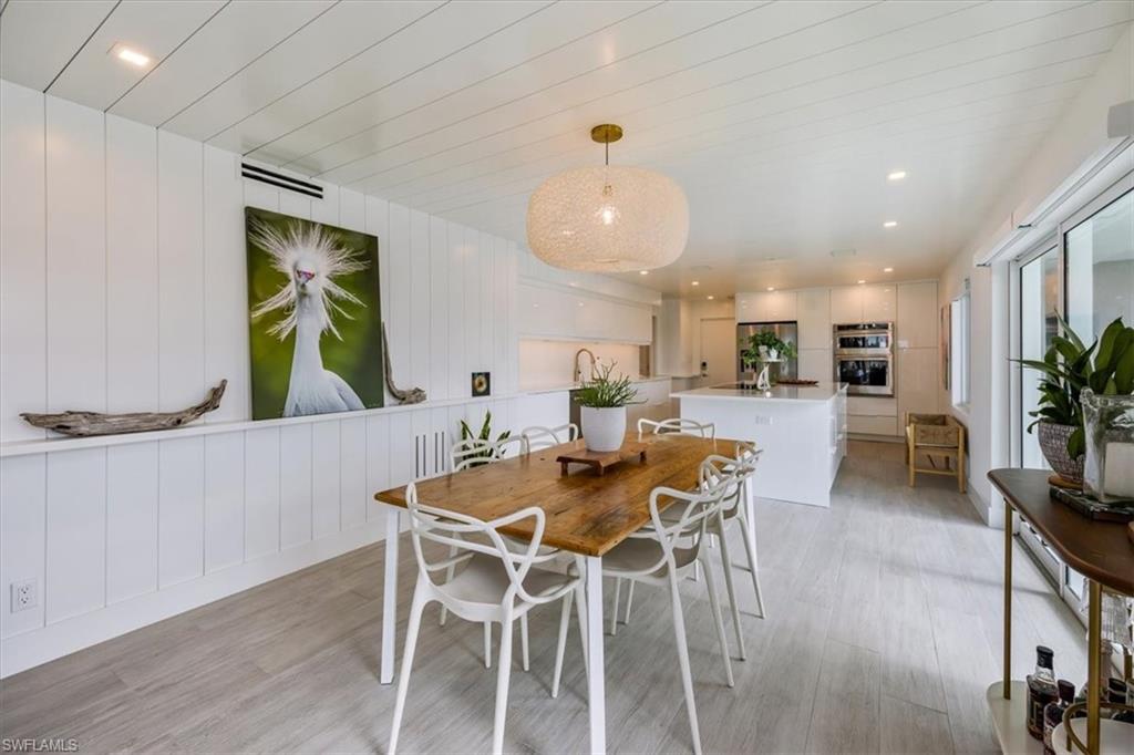 1100 8th Avenue South, Unit 123F Naples, FL 34102 - Photo 13 of 30 a view of a dining room with furniture and a potted plant