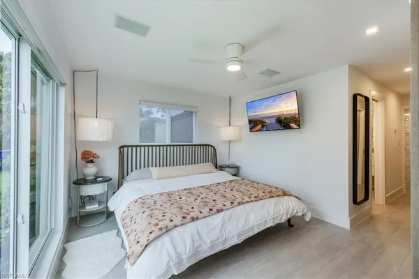a bedroom with a large bed and a tv
