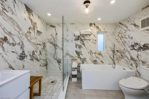 a bathroom with a toilet sink and mirror