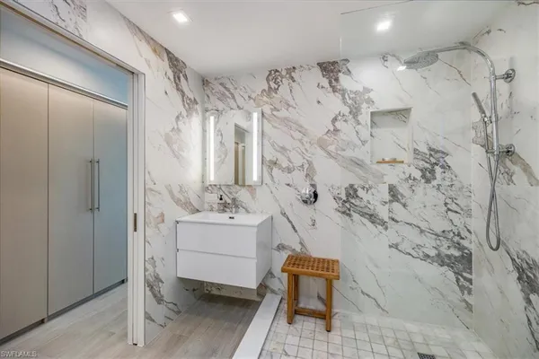 a bathroom with toilet sink and shower