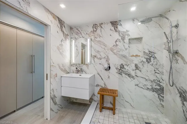 a bathroom with toilet sink and shower