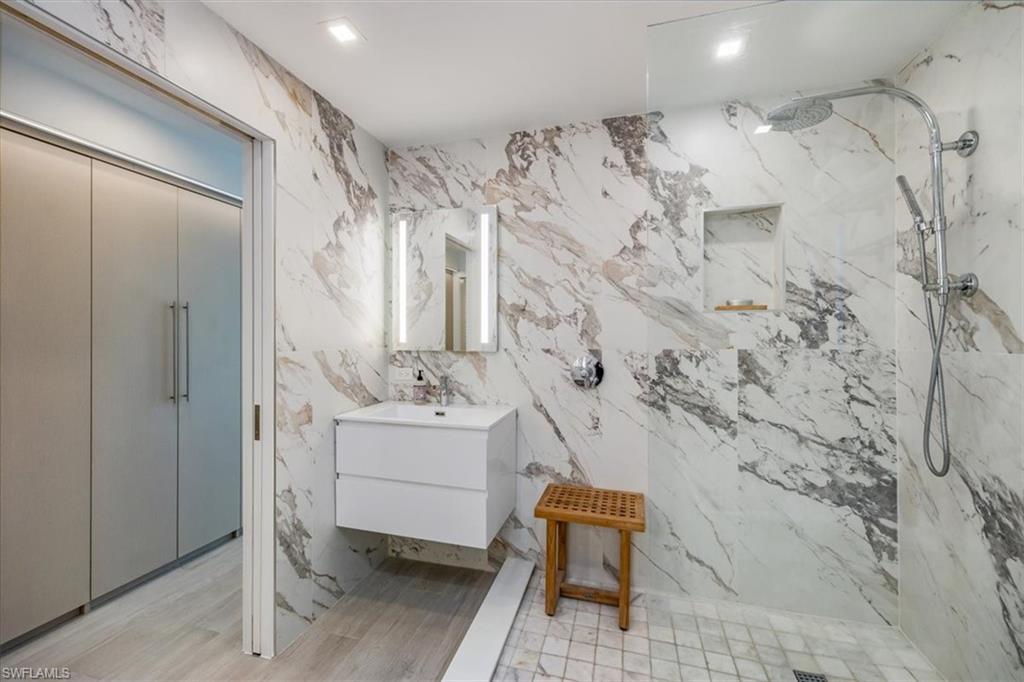 1100 8th Avenue South, Unit 123F Naples, FL 34102 - Photo 17 of 30 a bathroom with toilet sink and shower