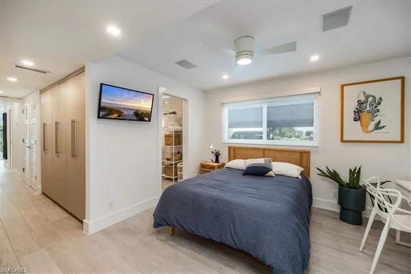 a bedroom with a bed and a television